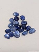 Group of loose blue sapphires on neutral background