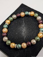 Full view of bracelet showing bead colours and rhinestone spacers