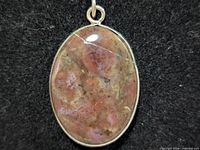 front view of oval jasper agate pendant in silver bezel