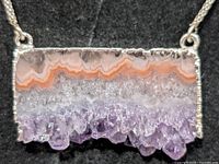 Close-up of pendant front showing banded agate and purple quartz crystals