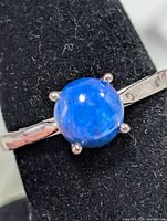 Front view of silver ring with blue lapis lazuli cabochon