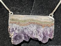 Front view of necklace showing agate and quartz crystal pendant on silver chain