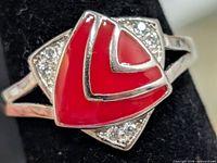 Front view of silver ring with red enamel geometric center and CZ accents