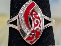 Front view of marquise face showing red enamel, CZ stones, silver setting