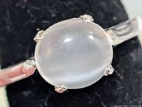 Top view of silver ring showing moonstone cabochon and prong setting