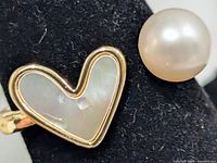 Close-up of heart mother of pearl inlay and freshwater pearl on ring