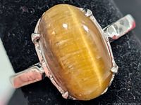 Front view of silver ring showing tiger eye cabochon
