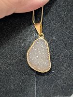Front view of agate/quartz druzy pendant showing crystal surface and metal bezel