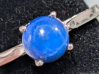 Top view of ring showing blue lapis lazuli cabochon in four-prong setting