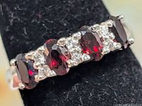 Front view showing five oval garnets and clear accents
