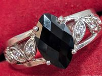 Front view showing marquise black onyx and CZ leaf accents