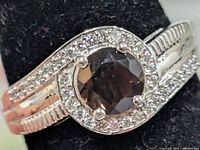 Front view showing smoky quartz center, CZ halo, and band detail