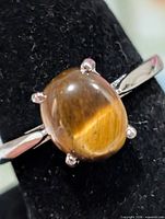 Front close-up of ring on display showing tiger eye gemstone