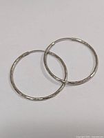 pair of silver hoop earrings side-by-side