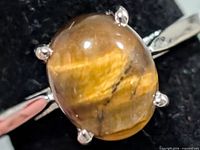 Close-up of oval tiger's eye stone in setting