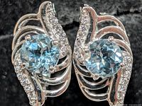front view showing gemstones and swirl setting
