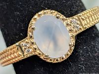 Front view of ring showing moonstone cabochon and accent stones