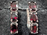 Front view showing garnet gemstones and silver setting