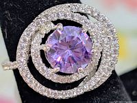 Top view of ring showing central lavender cubic zirconia and surrounding clear CZ halo