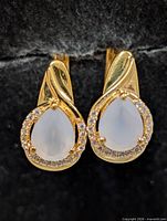 Front view showing pear moonstones, halo stones and gold finish