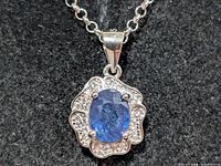Close-up of pendant showing sapphire and CZ details