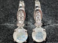 front view showing moonstone faces, silver mounts, accent stones