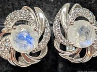 Front view showing moonstone cabochons and CZ swirl design