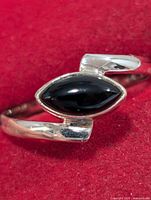 Front view of sterling silver ring with marquise black onyx stone