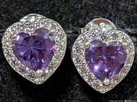 Front view showing purple heart CZ centers and halo of clear stones