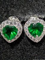 Front view of both heart-shaped green CZ stud earrings with surrounding clear stones