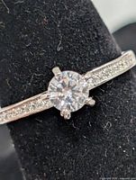 Close-up of ring head showing center CZ and shoulder accents