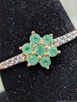 Front view showing emerald cluster and CZ shoulders