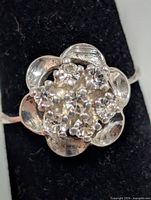 Front close-up of ring head showing flower design and stones