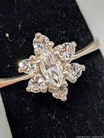 Top view of ring showing marquise center stone and six surrounding round stones