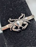 Front view of crab motif on silver ring