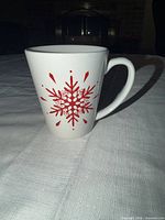 Full view of mug showing red snowflake design