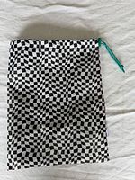 Full view of front side of drawstring bag showing pattern and shape