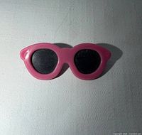 front view of pink sunglasses pin