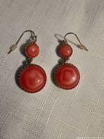 Full view of both earrings showing design and color