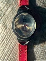 Close view of watch face showing dial, logo, numerals