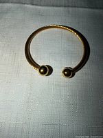 Cuff bracelet front view showing twisted cable and ball terminals