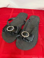 Top view of both flip flops showing bows and rhinestone rings