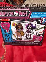 Front cover showing Monster High Power Ghouls Sketch Portfolio details, age recommendation and included contents