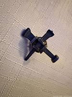 Front view showing cross shape and gold-tone wraps