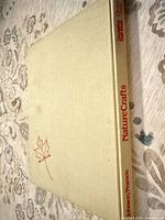 Front cover showing beige cloth and red maple leaf line art