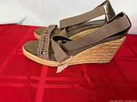 Side profile of right sandal showing jute-wrapped wedge heel, elastic ankle strap, decorative toe strap