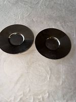 Top view of both metal Nespresso saucers