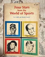 Front cover of paperback book with title and athlete photos