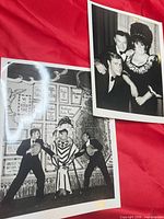 Two black & white photos on red cloth overview