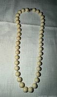Full view of entire cream bead necklace